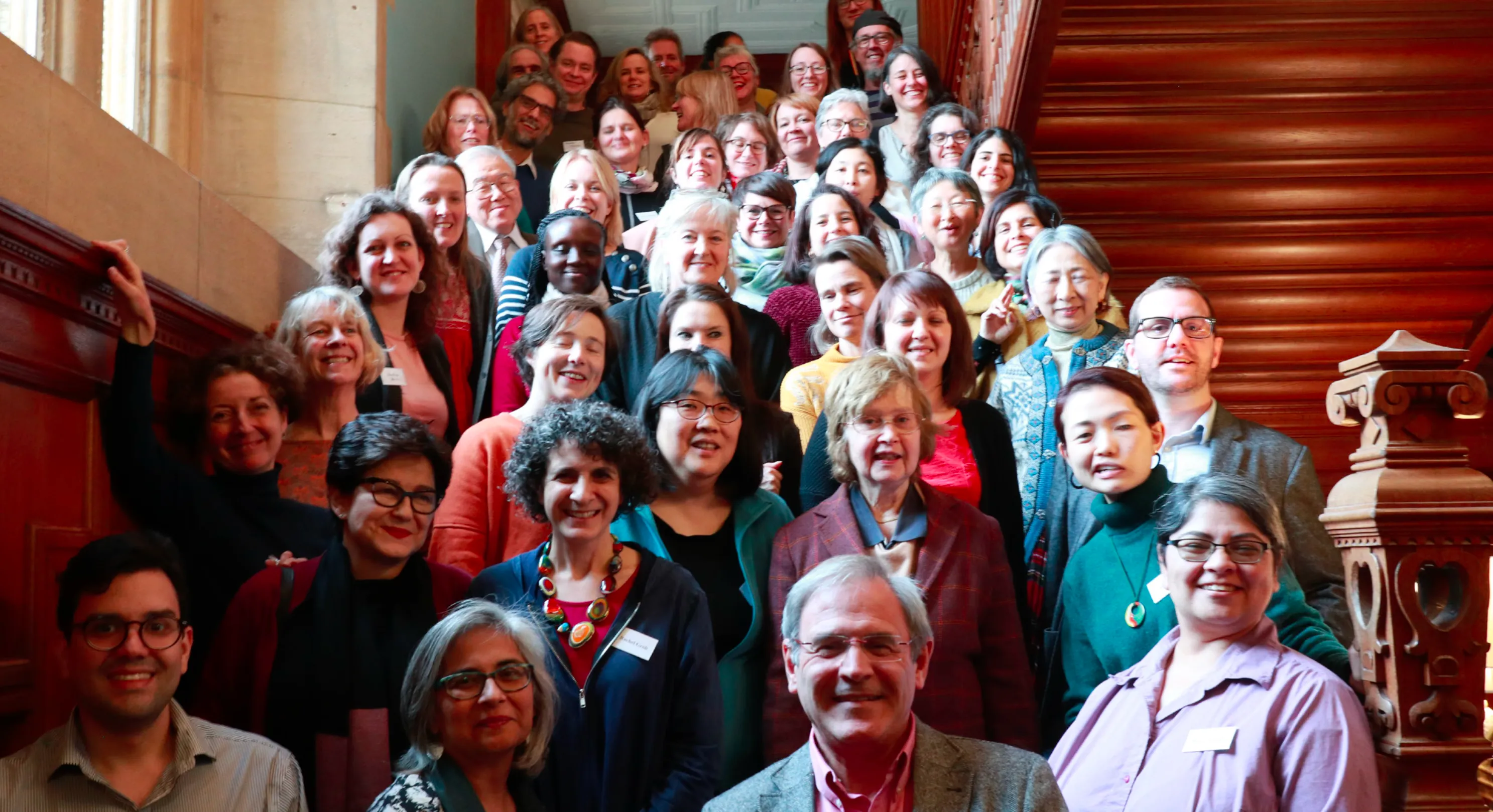 HEXI Members attendees on a large staircase at DIPEx International Conference